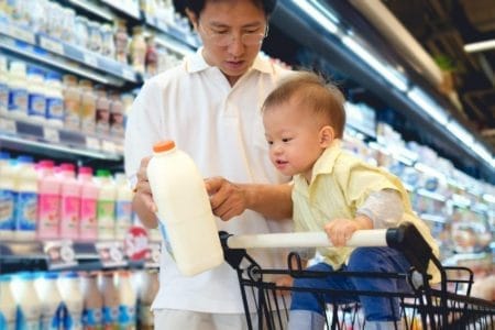 a father choosing milk product with his son | BookDoc
