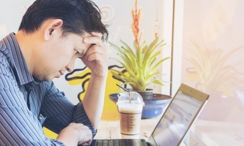 Businessman is working with laptop in coffee shop Tips to overcome a weight-loss plateau - Manage your stress | BookDoc