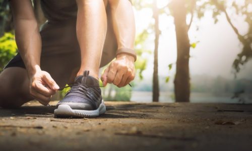 young-man-runner-tying-shoelaces_1421-46 Tips to overcome a weight-loss plateau - Increase your workout intensity and frequency | BookDoc