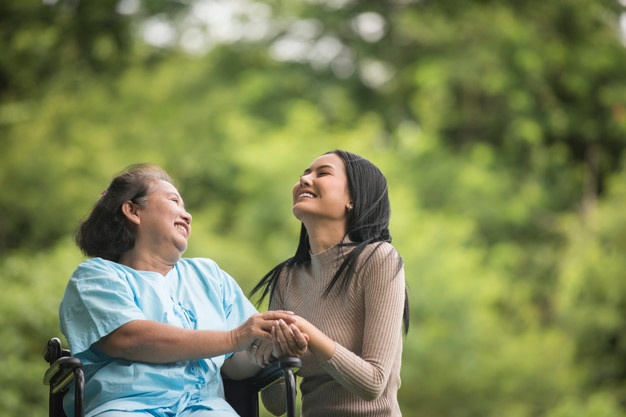 granddaughter-talking-with-her-grandmother-sitting-wheelchair-cheerful-concept-happy-family_1150-4340 elderly woman with her daughter | How to slow down your aging process | BookDoc