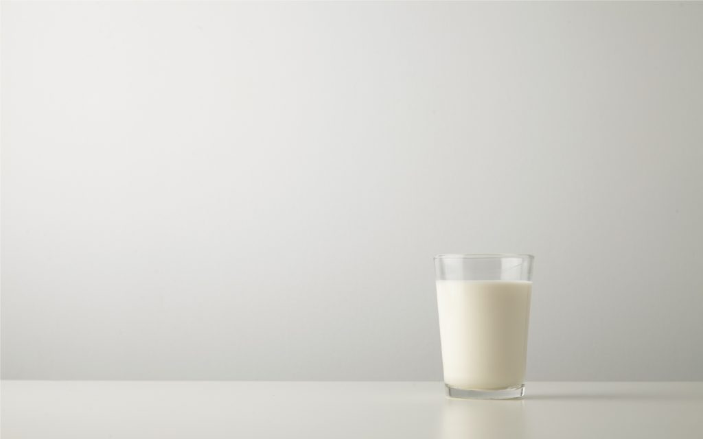 Transparent glass with fresh organic milk isolated on side of wh a glass of milk | BookDoc