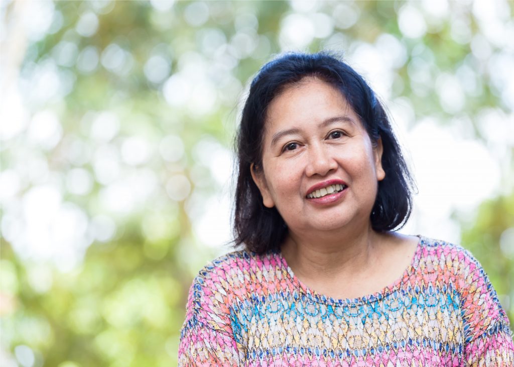 Portrait Middle aged female with happiness A happy middle aged woman | Osteoporosis in woman | BookDoc