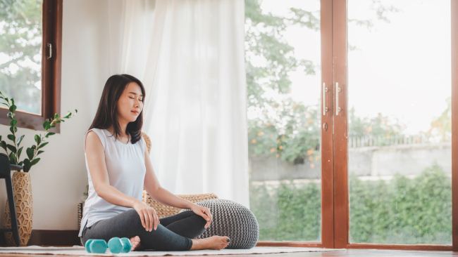 meditation a woman is meditating | featured image for productivity secrets through meditation | BookDoc