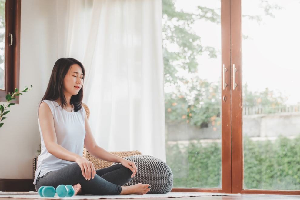 a woman is meditating | featured image for productivity secrets through meditation | BookDoc