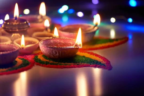 Oil lamps lit on street at night during diwali celebration Oil lamps lit on street at night during diwali celebration