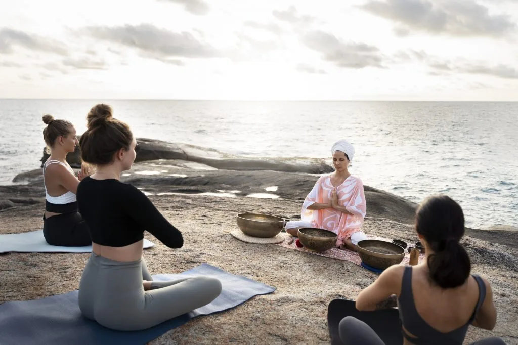 senior-meditation-guide-with-singing-bowls-sea