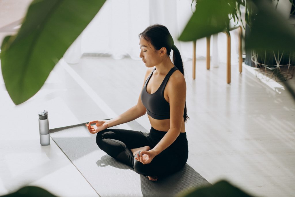 woman-practicing-yoga-mat-home (1)